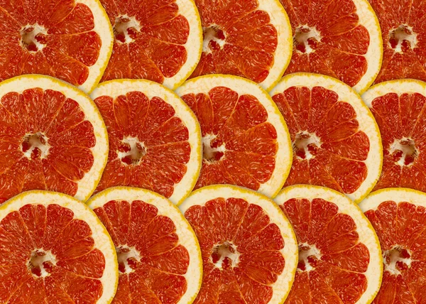 Abstracte rode achtergrond met citrus-fruit van grapefruit segmenten — Stockfoto