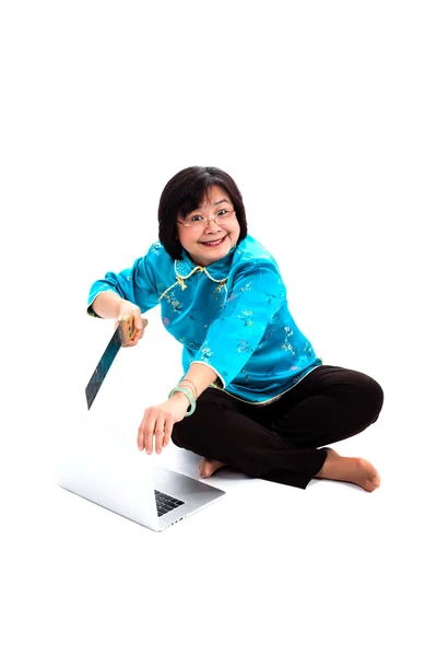 Chinese Woman destroying laptop with saw — Stock Photo, Image