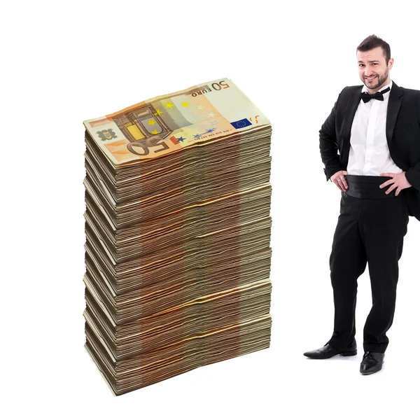 Man standing Next to Huge Stack of Money — Stock Photo, Image