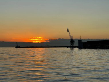 Denizde gün batımının sakin manzarası.
