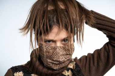 Woman having fun with a mask wearing brown mask, protecting herself from covid