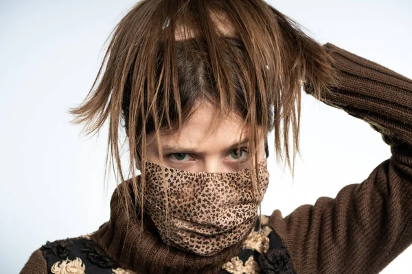 Woman having fun with a mask wearing brown mask, protecting herself from covid