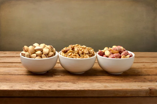 Nüsse Sortiment auf Holztisch — Stockfoto