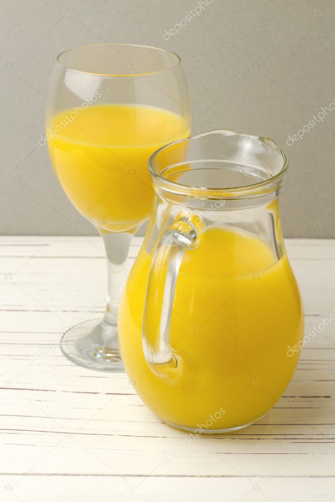 Fresh orange juice in jug and glass