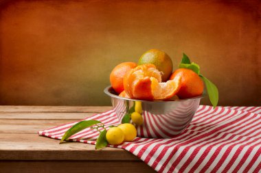 Still life with orange mandarins on wooden table clipart