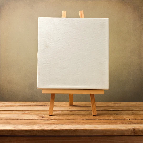 Background with blank canvas on wooden table — Stock Photo, Image