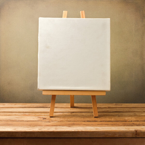 Background with blank canvas on wooden table