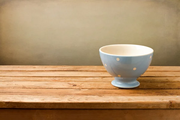 Empty blue bowl on wooden table — Stock Photo, Image