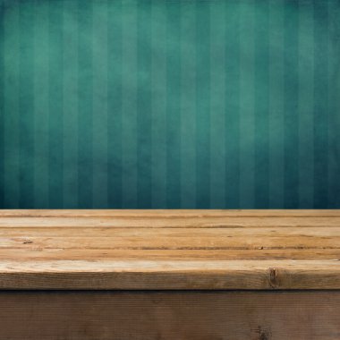 Vintage background with wooden table and grunge blue wall clipart