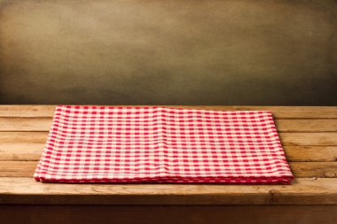 Empty table with tablecloth over grunge background clipart