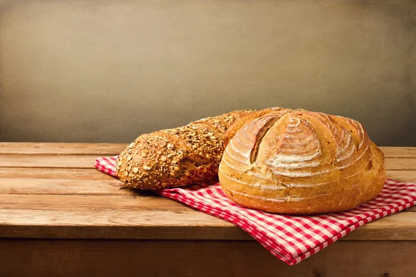 Fresh bread on tablecloth — Stock Photo, Image