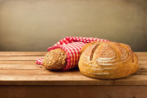 Fresh bread on wooden vintage table — Stock Photo, Image