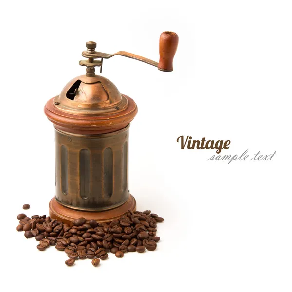 Vintage coffee grinder and coffee beans on white background — Stock Photo, Image