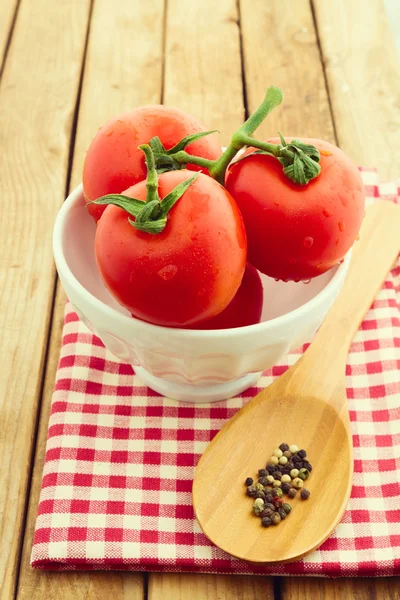 Fresh tomatoes in white bowl — Stock Photo, Image