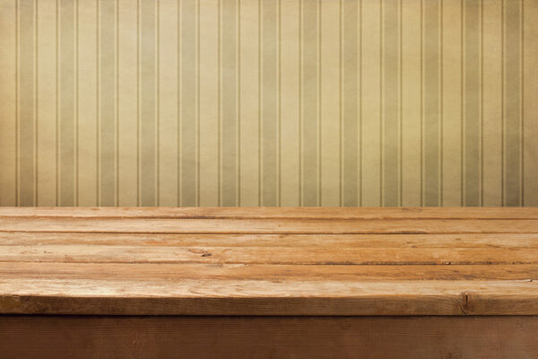 Vintage wooden deck table over retro wallpaper