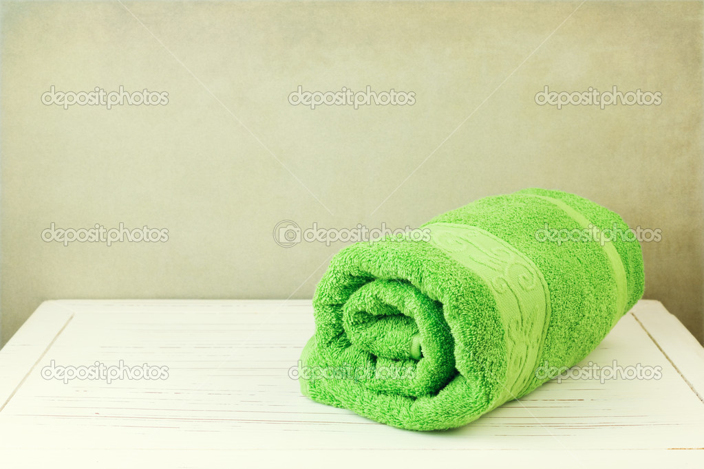 Fresh clean towel on white wooden table
