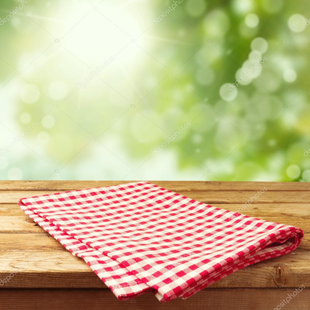 Empty wooden deck table with tablecloth