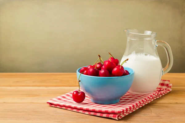 Bowl full of cherries and milk — Stock Photo, Image