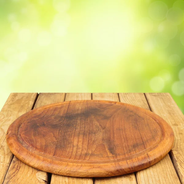 Wooden board on wooden table — Stock Photo, Image