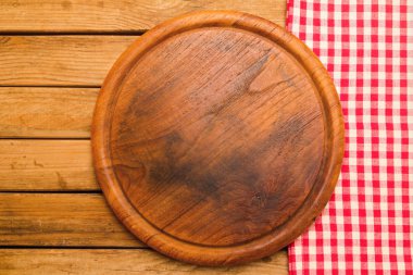 Bread board on wooden background with tablecloth clipart