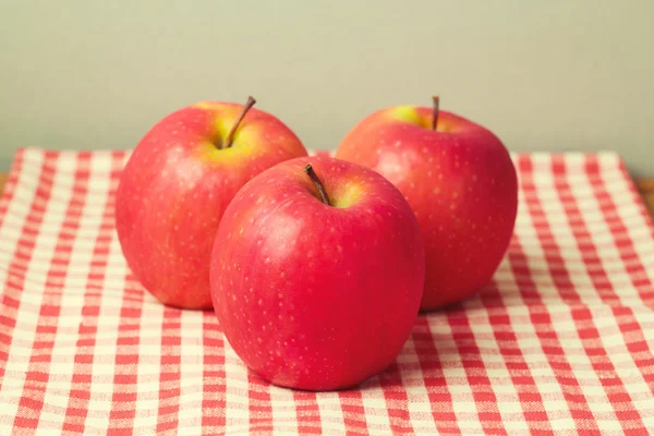 Frische Äpfel auf roter Tischdecke — Stockfoto