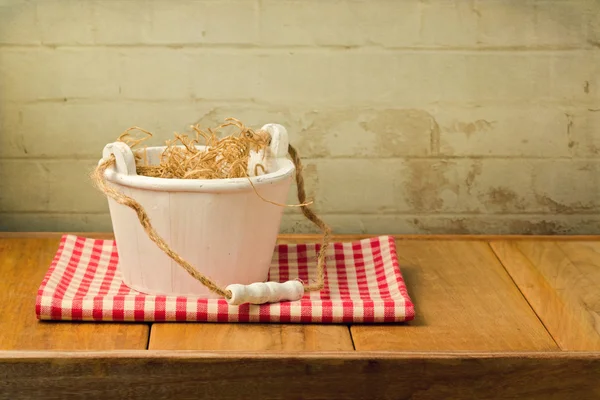 Wooden bucket on tablecloth — Stock Photo, Image