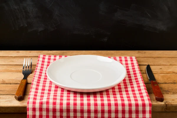 Empty plate with knife and fork — Stock Photo, Image