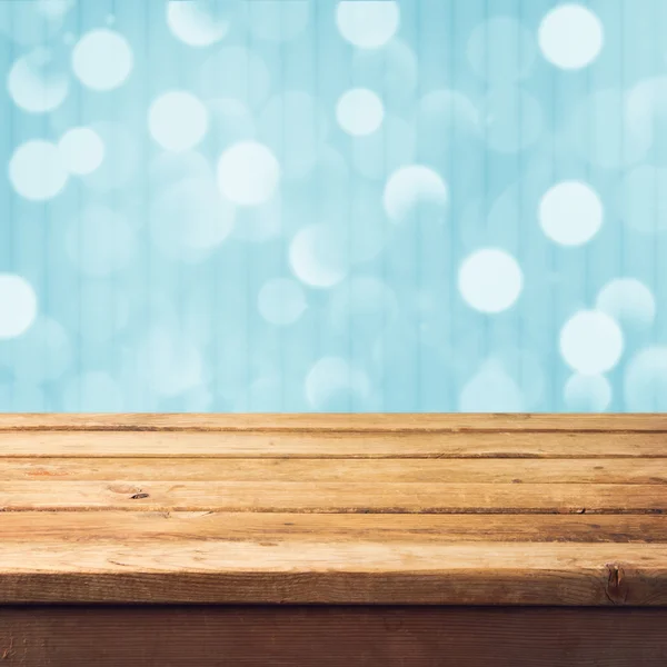 Winter bokeh background with wooden table — Stock Photo, Image