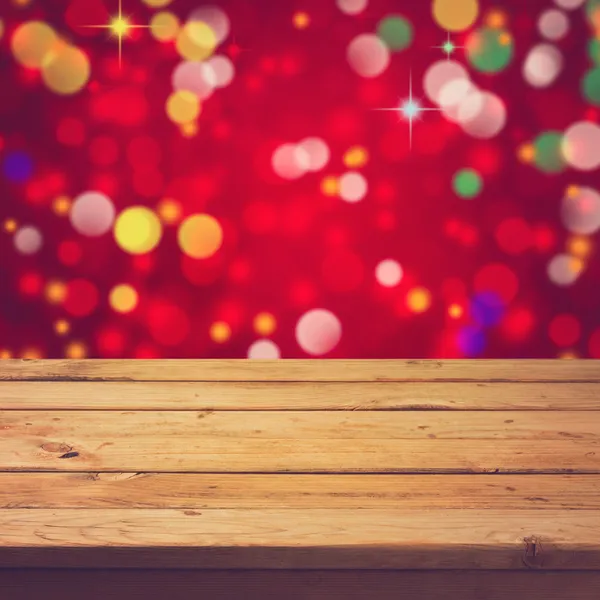 Deck table over festive bokeh background — Stock Photo, Image