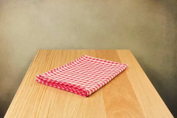 Wooden table with tablecloth — Stock Photo, Image