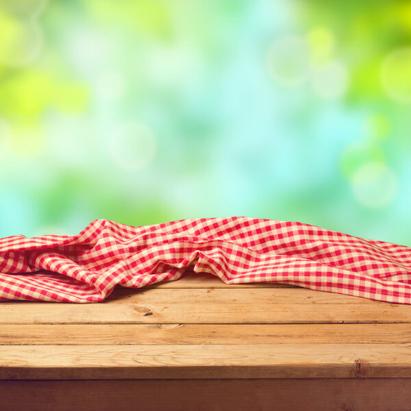 Empty wooden deck table with tablecloth