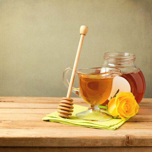 Honey jar on wooden table