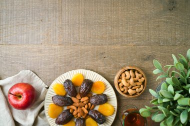 Dried dates, fruits and nuts for Jewish holiday Tu Bishvat celebration. Top view background.
