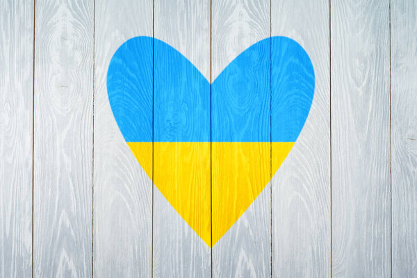  Heart shape with National flag of Ukraine on wooden board background