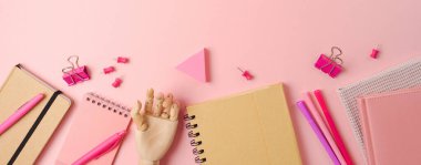 Back to school concept with notebook, planner and stationery on pink background. Top view, flat lay