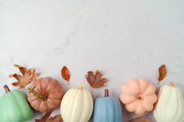 Thanksgiving holiday decoration concept. Pumpkin and autumn leaves on stone background. Top view, flat lay