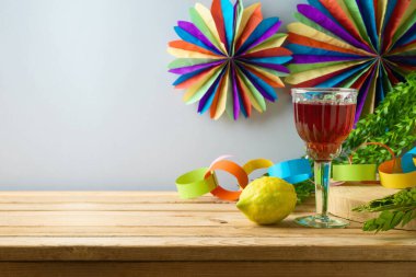 Jewish holiday Sukkot celebration background with traditional symbols and decorations on wooden table