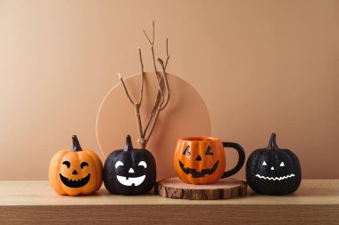 Cadılar Bayramı konsepti Jack o fener kahve fincanı ve simli balkabağı süslemesi ile ahşap masa üzerinde modern arka plan üzerinde