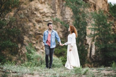 Taş bir uçurumun arkasında güzel bir çift. Birbirini seven bir çiftin portresi.