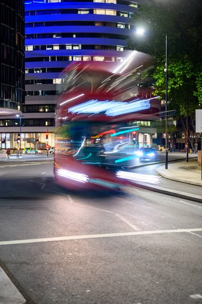 Long exposure red London Double Decker Bus at night with motion blur