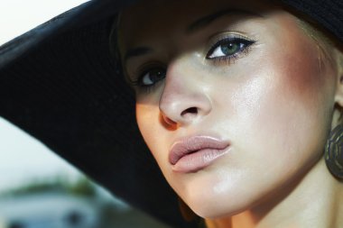 Close-up portrait of beautiful woman in hat. green eyes clipart