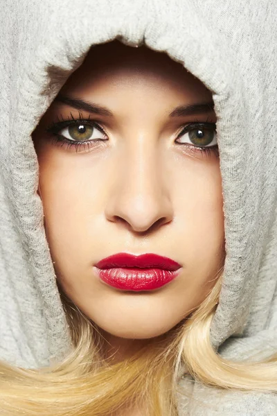 Beautiful blond woman in hood. red lips — Stock Photo, Image