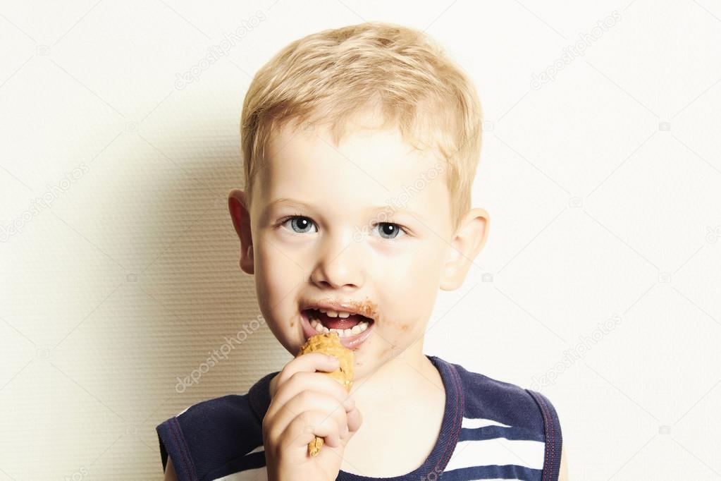 Smiling child. cute kid boy eating ice cream
