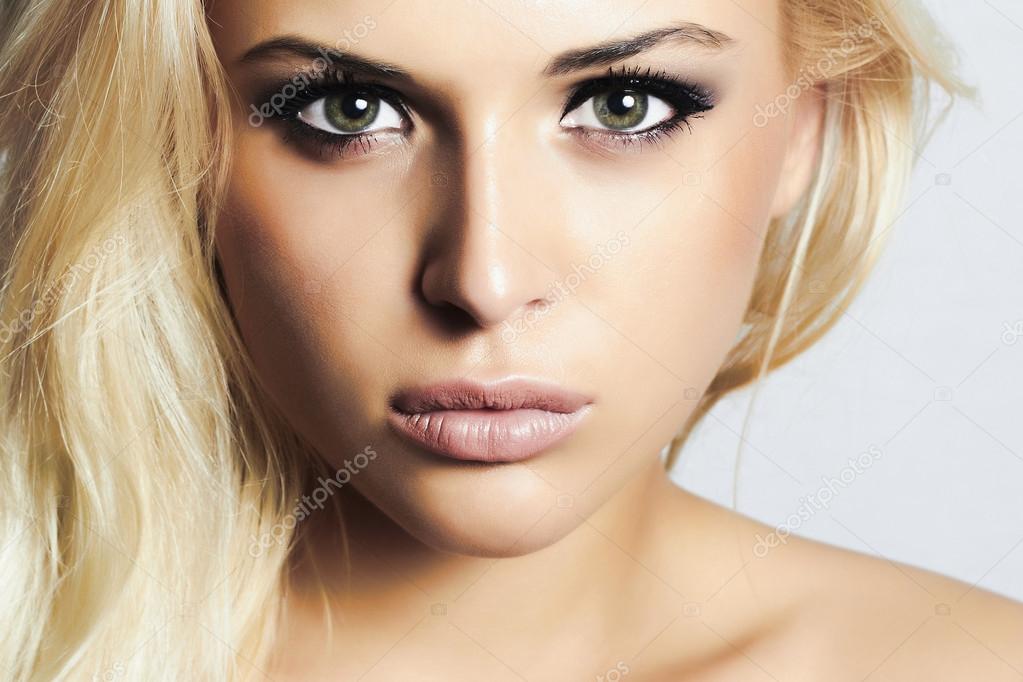 Beautiful blond girl with green eyes.woman.professional make-up