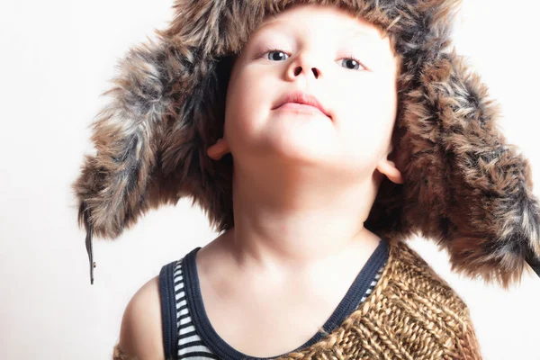 Sweet child in a fur hat. fashion funny kid. winter style. little boy. children — Stock Photo, Image