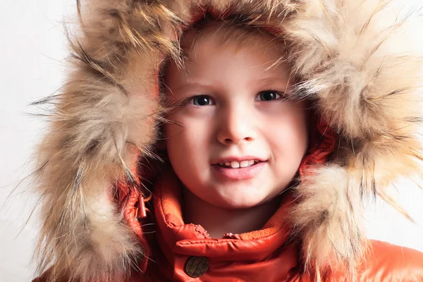 Child in fur hood and orange winter jacket. fashion kid.children.close-up — Stock Photo, Image