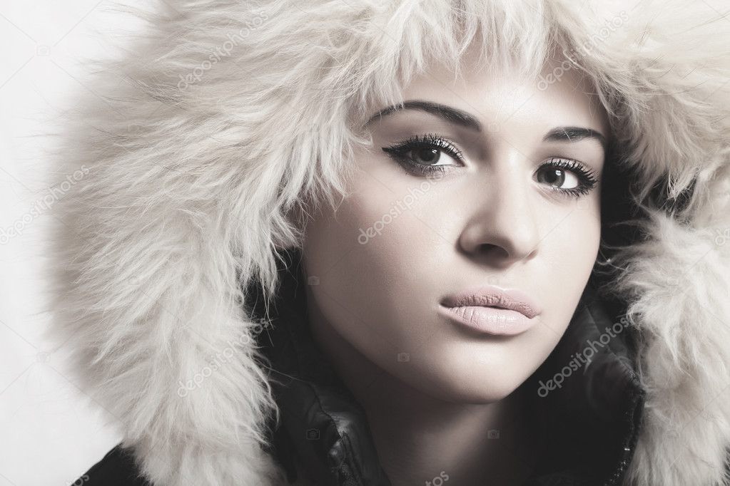 Beautiful woman with fur. white fur hood.monochrome