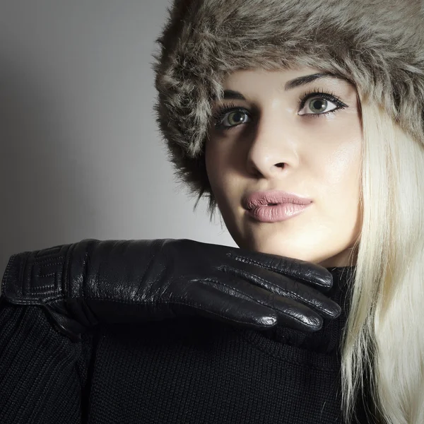 Uroda moda blond dziewczynka w futro kapelusz. piękne blond kobieta w skórzane rękawiczki. czarny sweter. moda zimowa — Zdjęcie stockowe