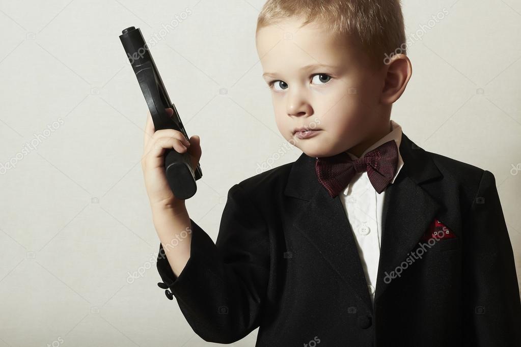 Handsome Boy with Gun.Fashionable Spy in .Stylish Agent 007. Fashion Children.Child in Bow tie. Elegance. Little James Bond Stock Photo by ©EugenePartyzan 39535547