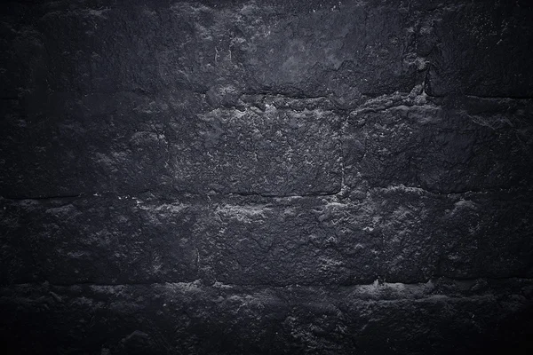 Dark stone wall texture background. Black bricks